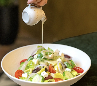 syrup pouring over fresh salad