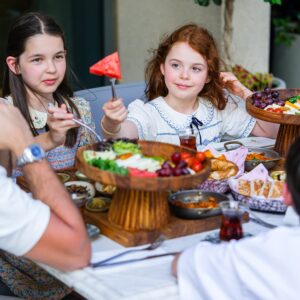 kids having meal in restaurant with family