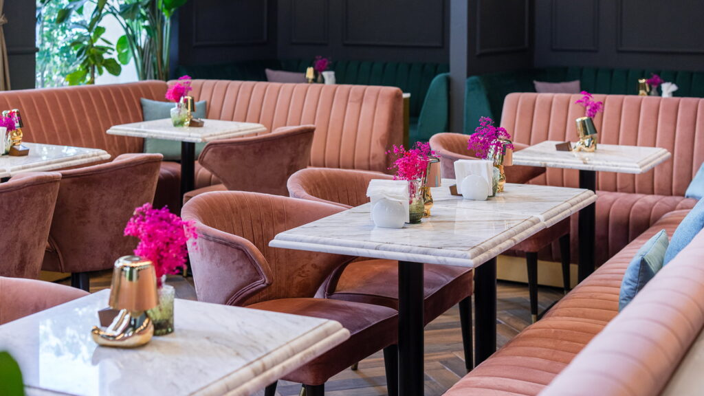 beautiful chair, table and sofas setup at Le Flamant rose restaurant