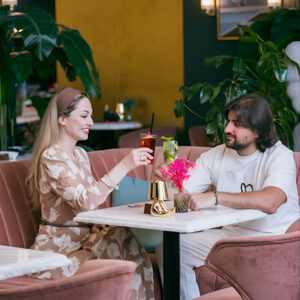 Couple enjoying a meal together at Le Flamant Rose restaurant in Dubai Creek Harbour with elegant décor and a cozy, family-friendly atmosphere