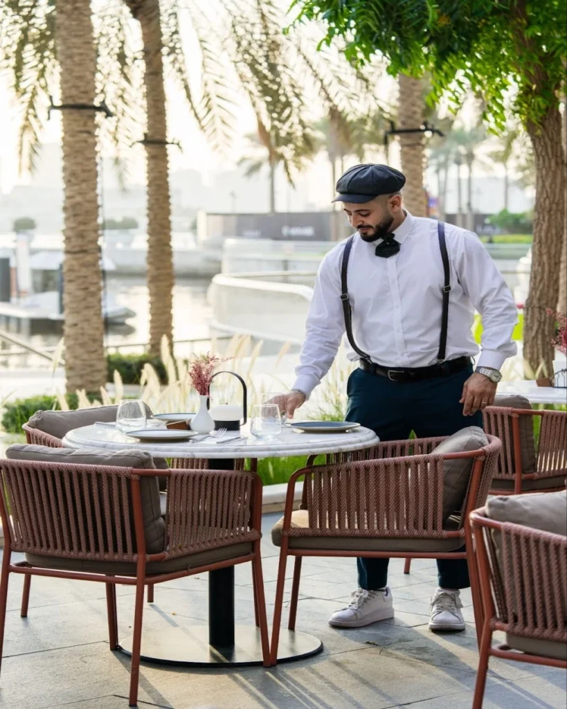 dining with a view, waiter setting up the table for dining